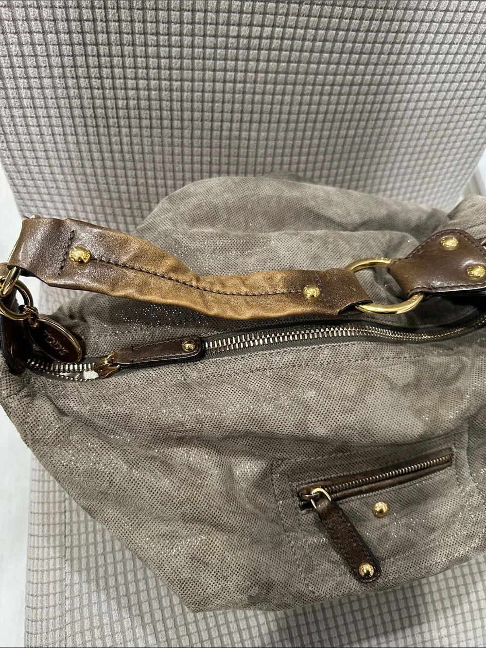 Tod’s Soft Metallic Taupe Hobo Bag with Gold Hardware. Lots of pockets,